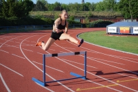 Atletka při skoku přes překážku